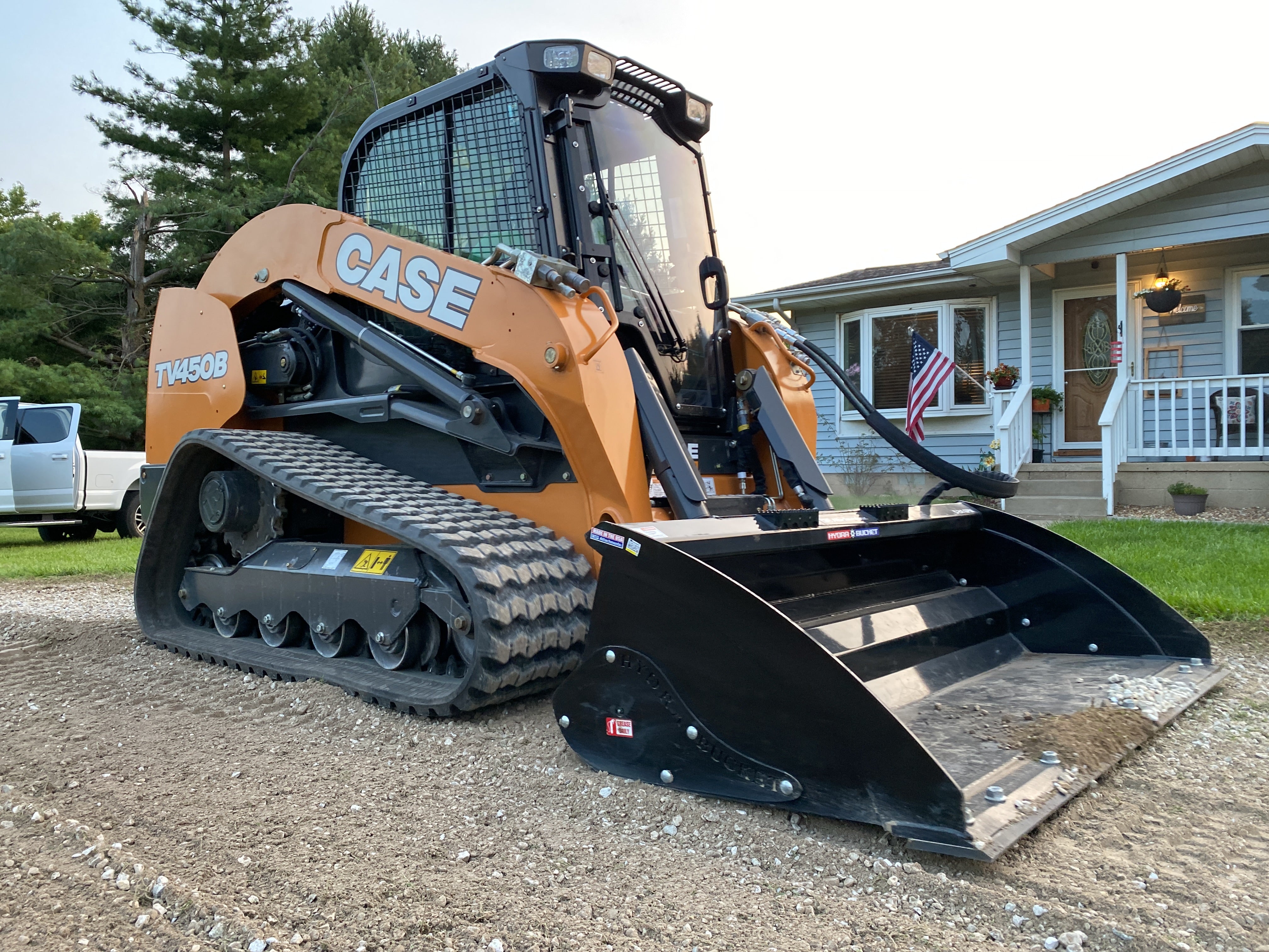 Hydra Bucket skid steer attachment grading a driveway