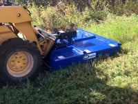 Thumbnail for  The image shows a mower attached to a yellow skid steer driving through a field of tall grass. The grass is green and appears to be freshly cut.