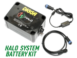 A close-up of a Halo System Battery Kit, showing the battery pack, carrying handle, and label. The label displays the branding and specifications of the battery.