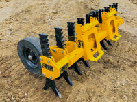 Thumbnail for A yellow tracked skid steer loader with black rubber tracks and a yellow plow attachment parked on a dirt construction site. 