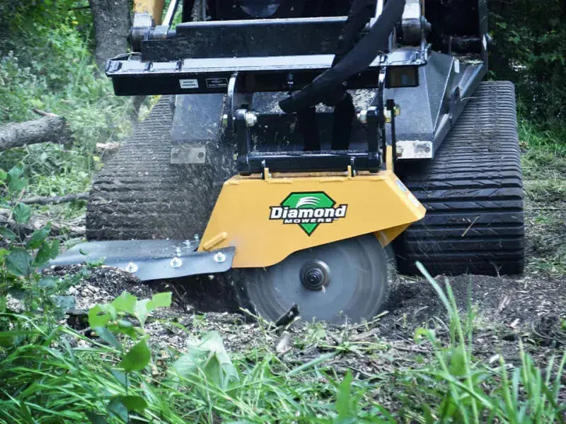 Close-up of a diamond mower's rotating teeth shredding a tree stump.