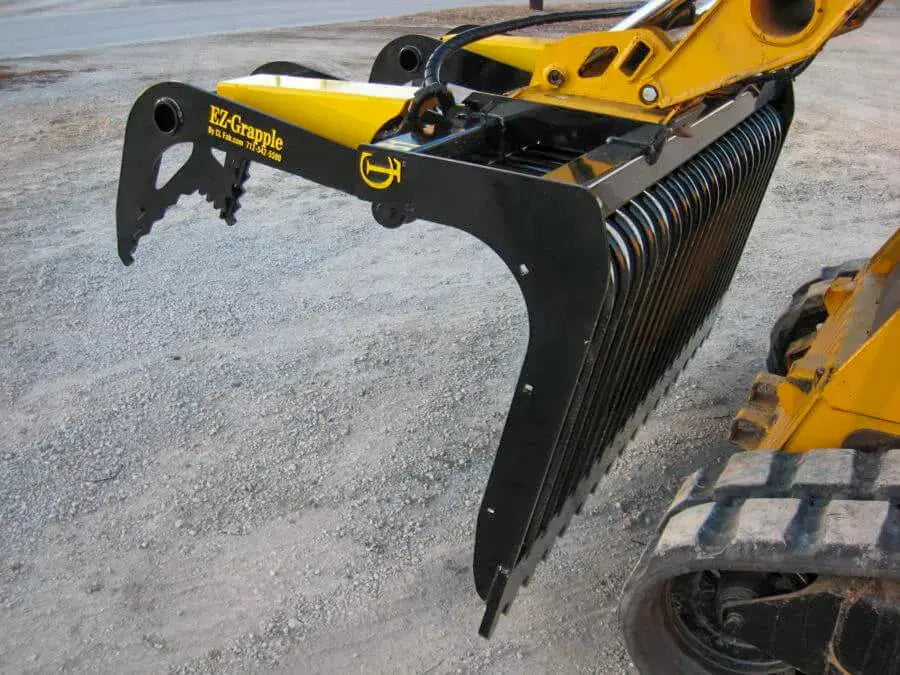 A skid steer with an EZ-Grapple attachment. 