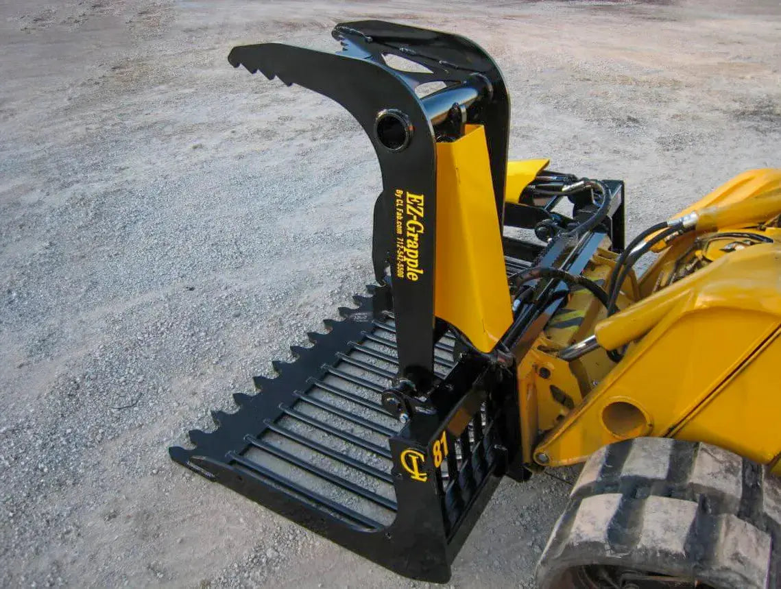 A close-up of a yellow and black industrial bucket, used for construction or landscaping work.