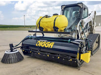 Thumbnail for A Digga Sweeper Bucket Broom Attachment in action, sweeping up debris on a paved surface.