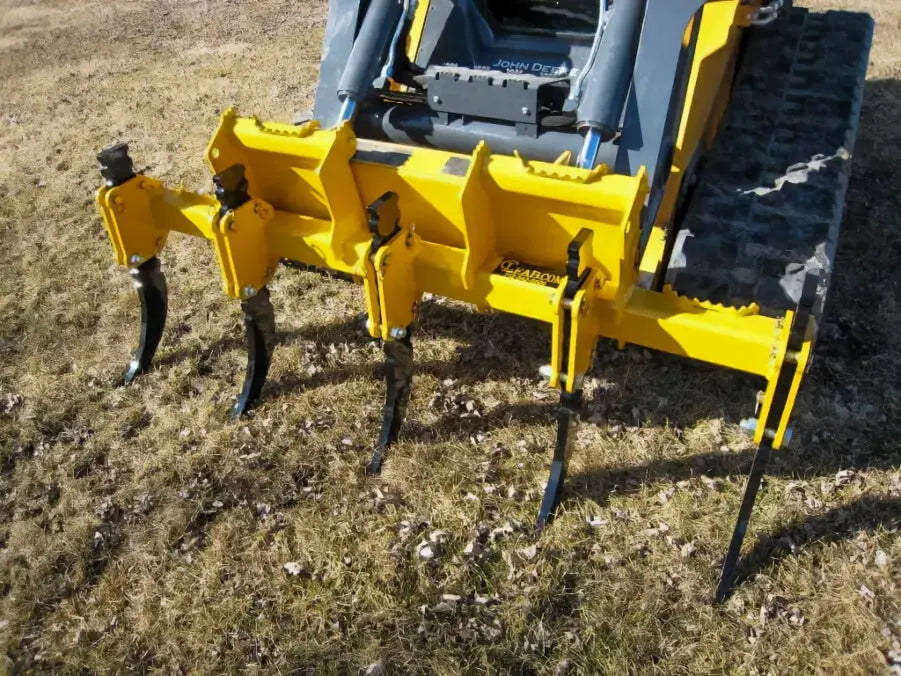 A 3D model of a farm tool with four curved, sharp teeth for ripping up tough ground.