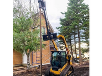 Thumbnail for A powerful construction vehicle, a bulldozer with a massive drill attached to its front, bores into the earth in front of a suburban home.